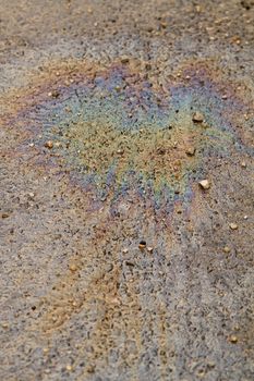 Photo of colorful oil spill on the road