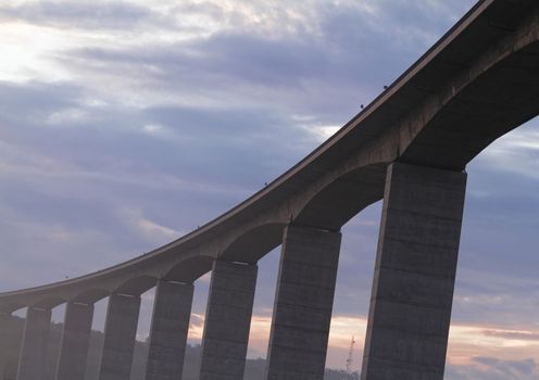 Large highway viaduct with foggy sunrise on autumn