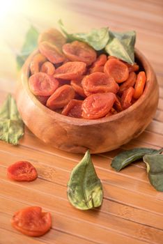 Dried apricots in a wooden bowl
