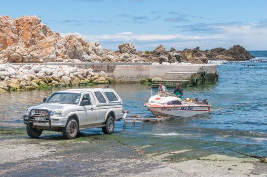 KLEINMOND, SOUTH AFRICA - DECEMBER 23, 2014: Crayfish boat being pulled with the days catch onto a trailer at Kleinmond harbor
