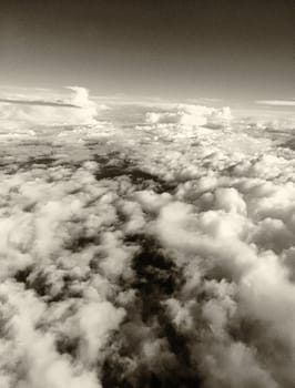 Fluffy clouds in the sky, black and white view from aircaft.