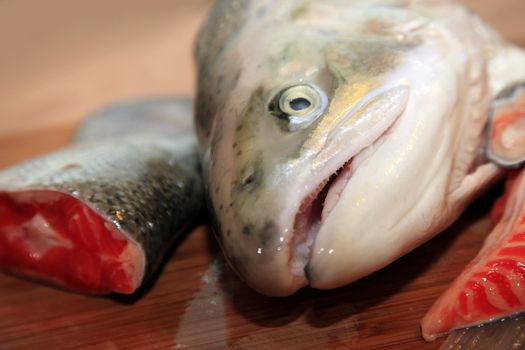 Fresh red salmon fish on wooden cooking desk