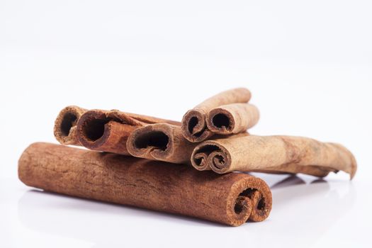 group of dried cinnamon stics isolated on white background