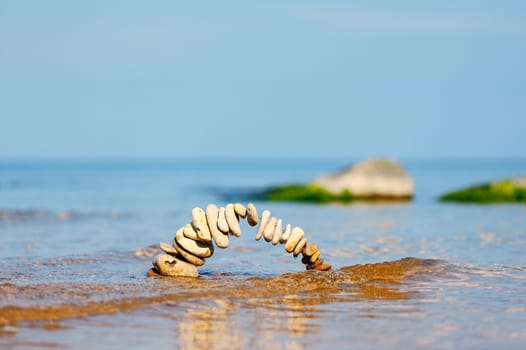 Circle of pebbles on the surface of the sea