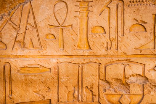 Detail of ancient stone wall and hieroglyphs, Queen Hatshepsut temple, Egypt