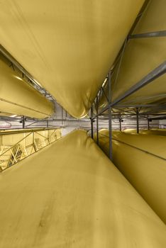 Industrial interior with welded silos from above