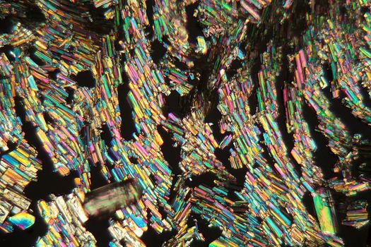 Alanine is a amino acid which occurs in the human body. The photo is made with a magnification of 100x and in polarized light. The sample is pure Alanine precipitated from a solution on a microscope slide.