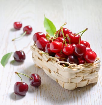 ripe cherries in small basket