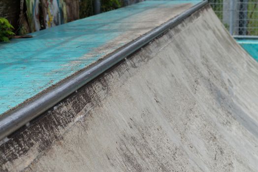 A quarter pipe for skating or bmx made of cement.