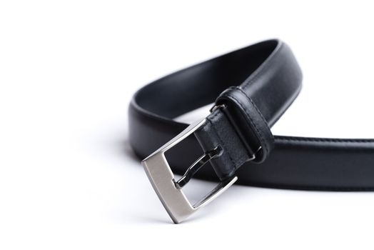 A black leather belt isolated on a white background.