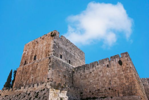 Defensive wall of the ancient holy Jerusalem, lit by the bright sun.