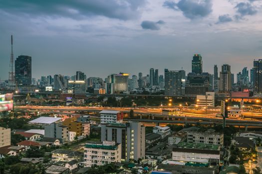 Business Building Bangkok city area at night life with transportation way, logistic concept high angle bird eyes view