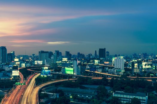 Business Building Bangkok city area at night life with transportation way, logistic concept high angle bird eyes view