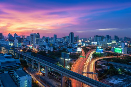 Business Building Bangkok city area at night life with transportation way, logistic concept high angle bird eyes view