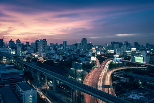 Business Building Bangkok city area at night life with transportation way, logistic concept high angle bird eyes view