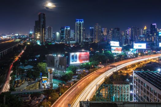 Business Building Bangkok city area at night life with transportation way and moon, logistic concept high angle bird eyes view