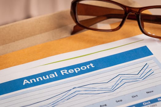 Annual Report letter document and eyeglass