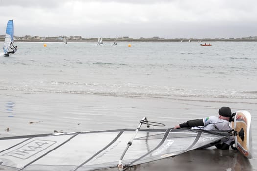 windsurfer having a nap on the beach in the maharees county kerry ireland