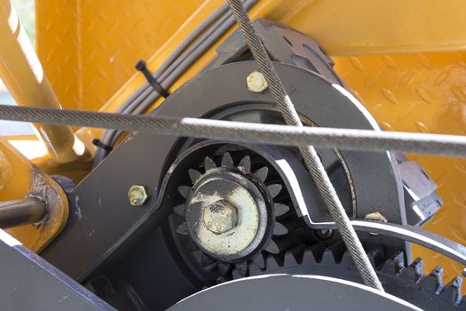 A closer photo of a cogwheel on an industrial crane