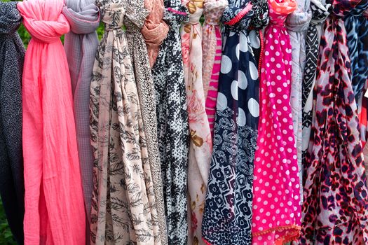 Beautiful colorful scarves hanging  in a fashion accessories shop                               