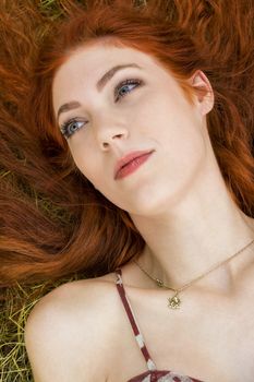 Close up Very Happy Young Woman Lying on Grassy Ground