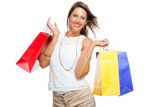 Very Happy Stylish Woman Raising Three Colored Shopping Paper Bag with Mouth Open and Looking at the Camera. Isolated on White Background.