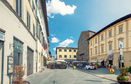 AREZZO, ITALY - MAY 12, 2015: Tourists walk along city streets. Arezzo is a famous medieval city of Tuscany.