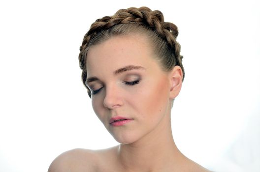 Young female model with closed eyes. Gentle and relaxed face expression, white background.
