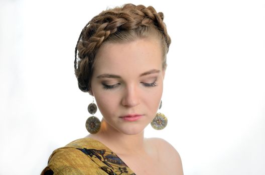 Young Polish female model. Girl wears yellow scarf and earrings.