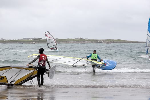 windsurfers getting ready to race and surf on the beach in the maharees county kerry ireland