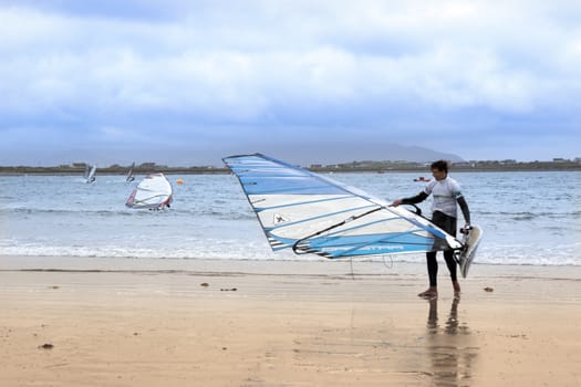 windsurfing champion getting ready to race and surf on the beach in the maharees county kerry ireland