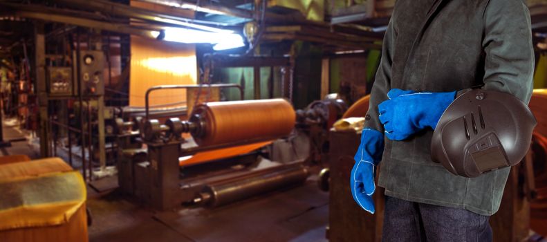 Worker with instruments at industrial factory