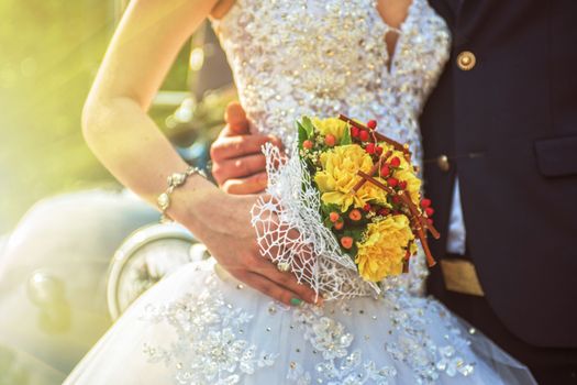 Beautiful wedding bouquet in hands of the bride