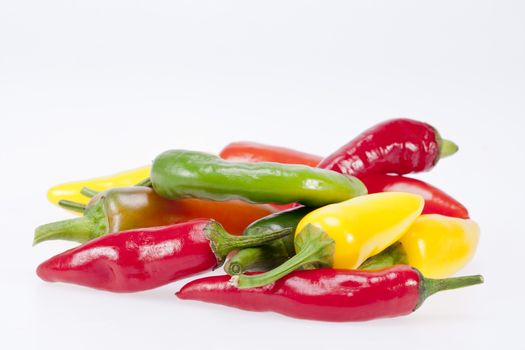 heap of colorful raw chili pepper isolated on white background