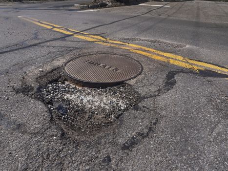 Big pothole caused by freezing and thawing during spring season
