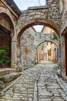 A typical narrow street or alley with stone houses in the town of Bale or Valle in Istria, Croatia, situated on a hilltop.