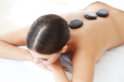 woman having stone therapy at spa session