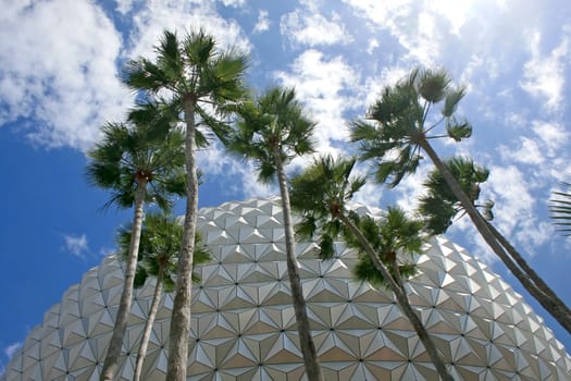A modern building with palm trees in front