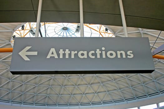 A sign with the word Attractions and an arrow
