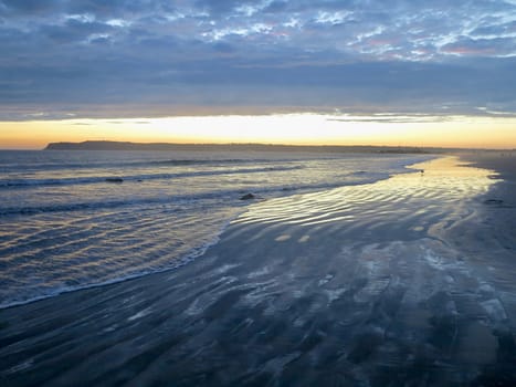 A cloudy golden sunset over the ocean