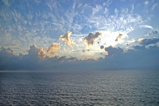 A sunset on the horizon of the ocean