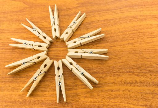 Ten Wooden Clothespins Arrange in Star Shape Place on Wooden Table Background