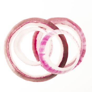 4 Red onion slices isolated on white background