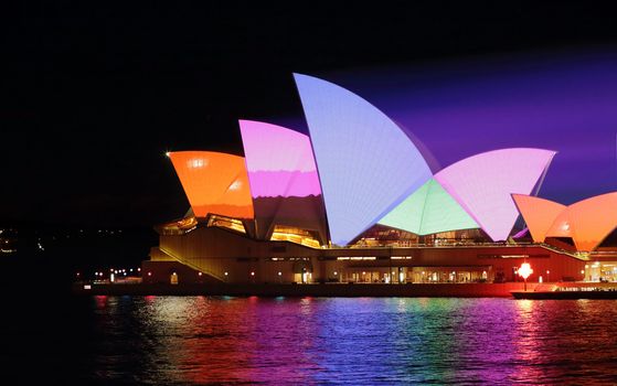 SYDNEY, AUSTRALIA - JUNE 2, 2015;   Sydney Opera House in bold dynamic colourful patterns for Vivid Sydney annual festival event. Prominant colours of orange pink, blue and green