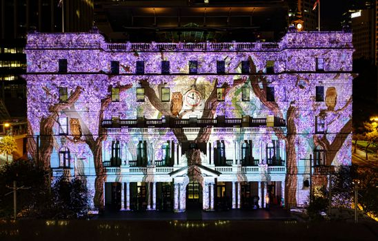 SYDNEY, AUSTRALIA - JUNE 2, 2015;  Customs House is one of the buildings brought to life in vivid colours, patters and imagery during Vivid Sydney annual festival event.   Owls and wisteria on display.