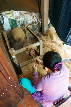 BEN TRE, VIET NAM- JUNE 1: Asian woman working at home, Vietnamese female spin coconut fiber to make material for coir mat, a tradition product from coconut, Bentre, Vietnam, June 1, 2015