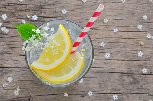 Elder lemonade with ice on old table wood