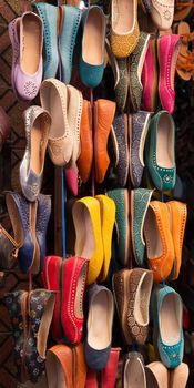 Colourful women leather shoes on display in a bazaar in the Medina of Marrakech, Morocco.