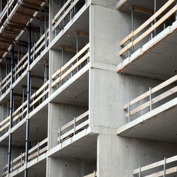 closeup of construction site with concrete walls with wooden safety banisters
