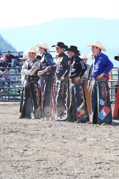 MERRITT, B.C. CANADA - May 30, 2015: Bull riders riding in the opening ceremony of The 3rd Annual Ty Pozzobon Invitational PBR Event.